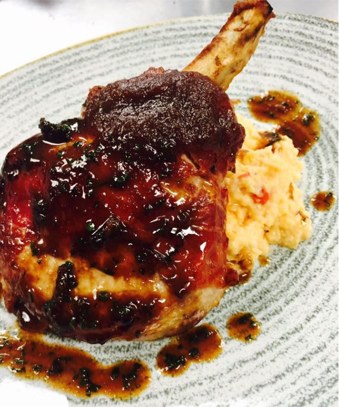 How about a smoked pork chop with pimento grits? You can get this when Red Barn Kitchen opens July 18. | Photo courtesy of Red Barn Kitchen