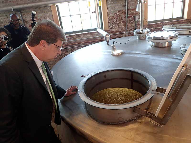 Angel's Envy CIO, Wes Henderson, looks into a mash fermenter. | Photo by Steve Coomes